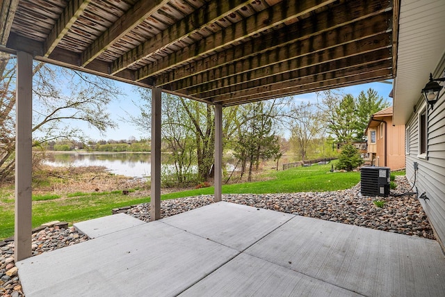 view of patio / terrace featuring central AC unit and a water view