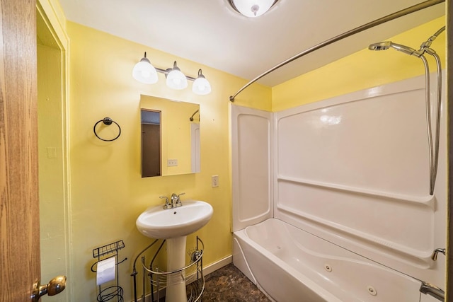 full bathroom with a sink, baseboards, and a combined bath / shower with jetted tub