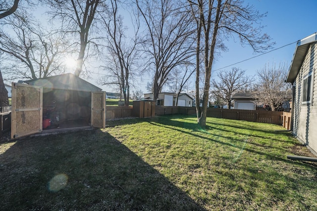 view of yard with an outdoor structure and a fenced backyard