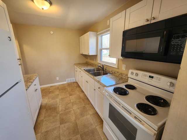 kitchen with white appliances, white cabinetry, visible vents, and a sink