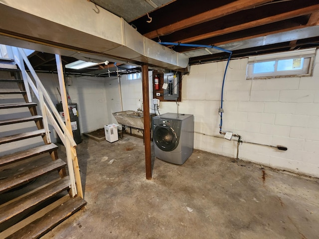 basement featuring water heater, electric panel, stairway, and washing machine and clothes dryer
