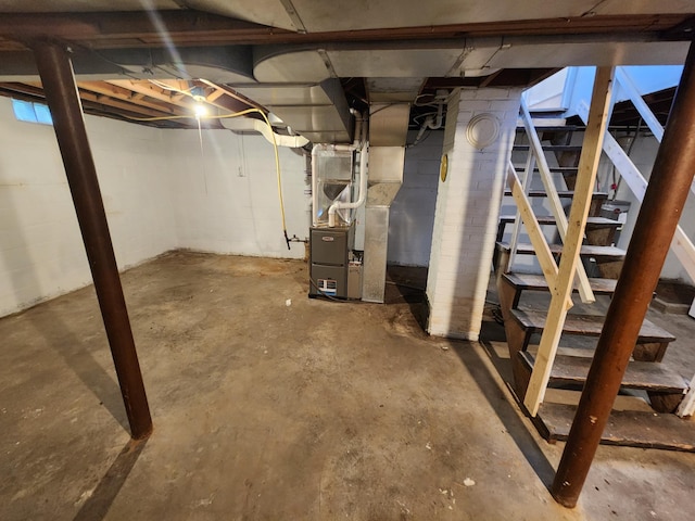unfinished basement with heating unit and stairs