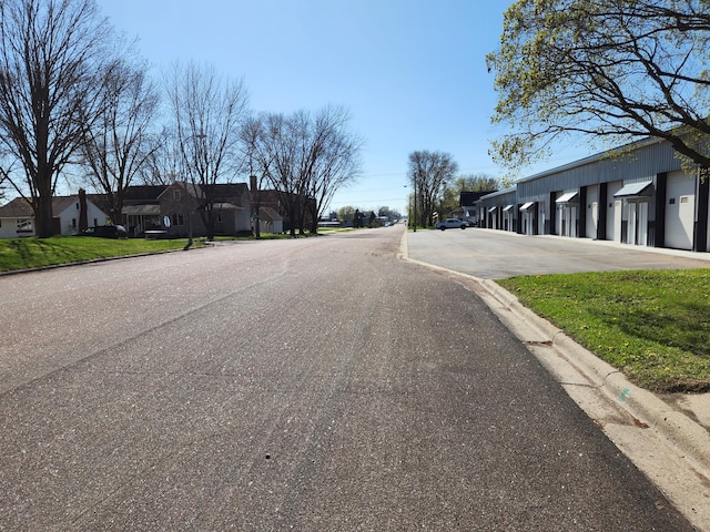 view of road featuring a residential view and curbs