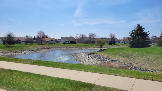 exterior space with a residential view, a water view, and a yard