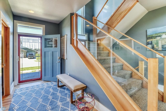 entryway featuring wood finished floors and stairway