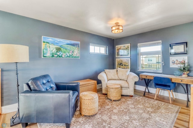 sitting room featuring baseboards and wood finished floors