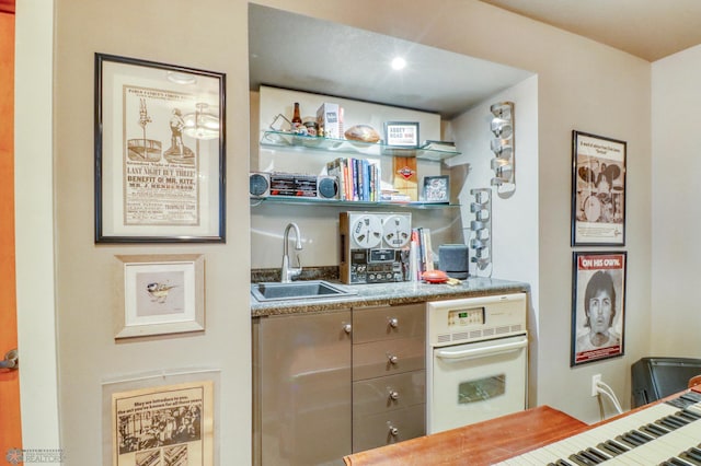 bar featuring a sink and white oven