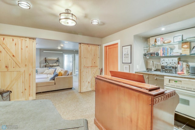 interior space featuring oven, a sink, and light speckled floor