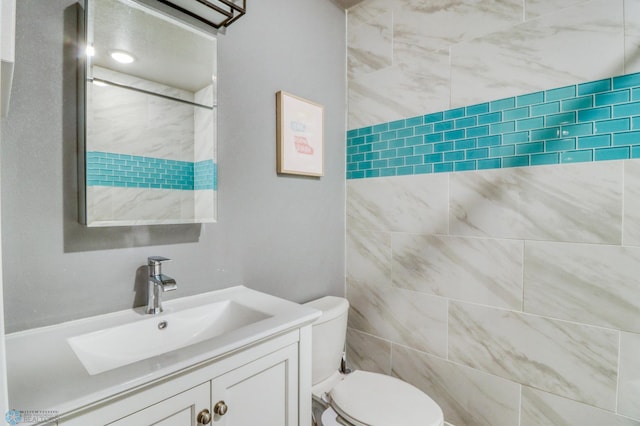 bathroom with toilet and vanity