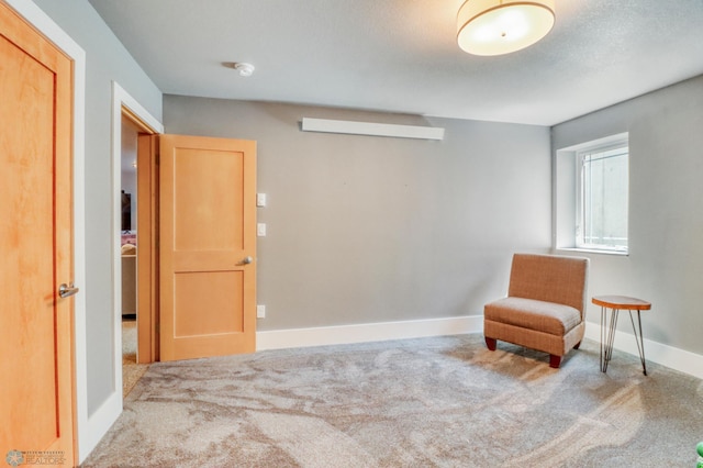 sitting room with carpet floors and baseboards