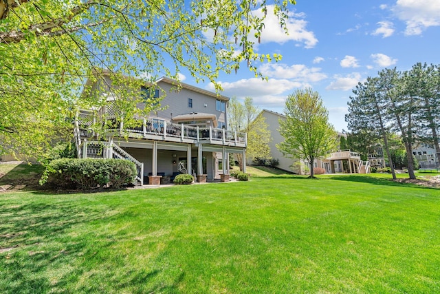 back of house featuring a deck, a yard, and stairs