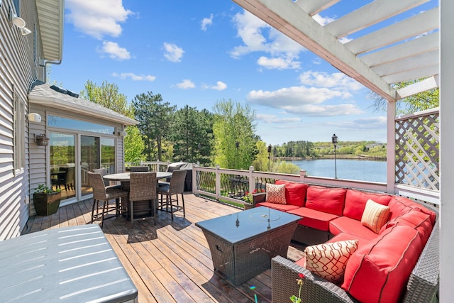 deck featuring outdoor lounge area, a water view, outdoor dining area, and a pergola