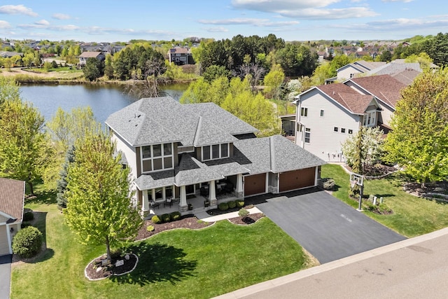 aerial view of residential area featuring a large body of water