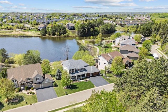 aerial view of residential area featuring a large body of water