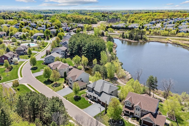 aerial view of residential area featuring a large body of water