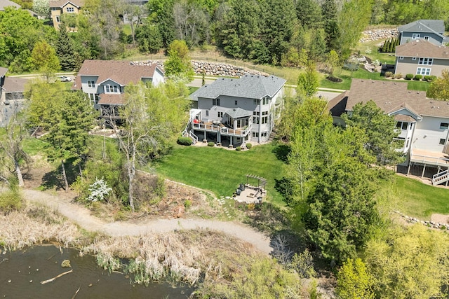 aerial perspective of suburban area with a nearby body of water