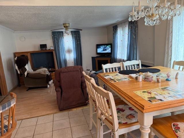 40171 Clitherall Lake Rd, Clitherall Twp, MN 56524 - dining room featuring light tile patterned floors, ceiling fan, and a textured ceiling