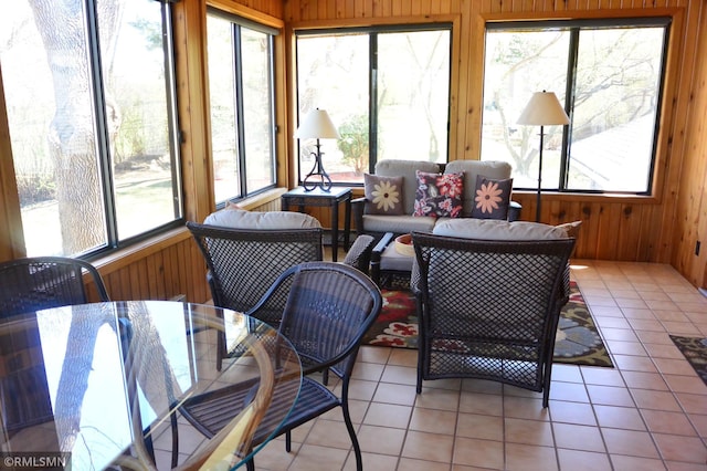 sunroom / solarium with an outdoor living space, a healthy amount of sunlight, and outdoor dining area