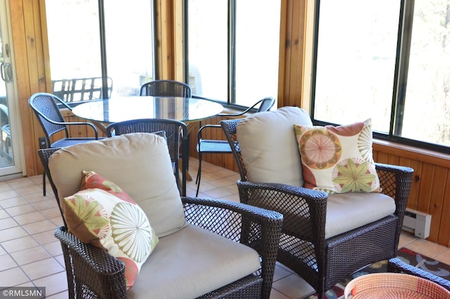 sunroom featuring a baseboard heating unit