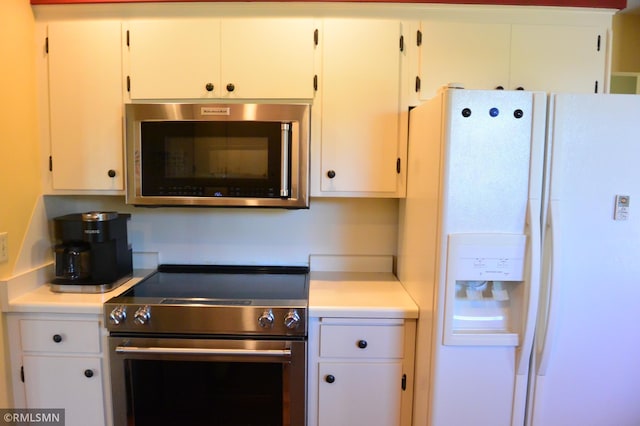 kitchen with stainless steel appliances and white cabinetry