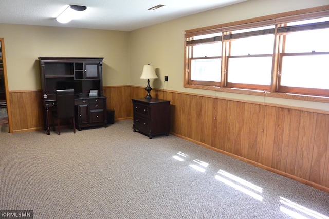 office area featuring wooden walls, wainscoting, and carpet floors