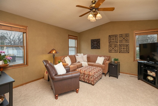 living room featuring baseboards, a ceiling fan, vaulted ceiling, and light carpet