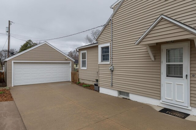 view of side of property featuring a detached garage and an outdoor structure