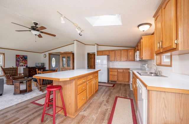 2765 Fraser St, La Prairie, MN 55744 - kitchen featuring a sink, light wood finished floors, white appliances, a textured ceiling, and lofted ceiling with skylight