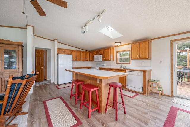2765 Fraser St, La Prairie, MN 55744 - kitchen featuring light countertops, light wood-style floors, white appliances, and a textured ceiling