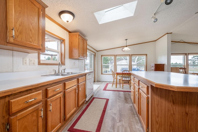 2765 Fraser St, La Prairie, MN 55744 - kitchen with ornamental molding, a textured ceiling, vaulted ceiling with skylight, a sink, and dishwasher