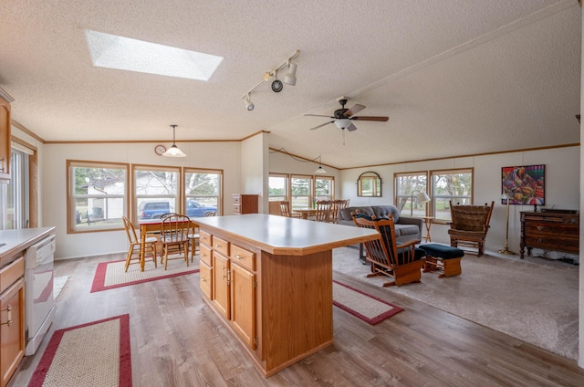 2765 Fraser St, La Prairie, MN 55744 - kitchen featuring white dishwasher, light wood-type flooring, light countertops, a textured ceiling, and a ceiling fan