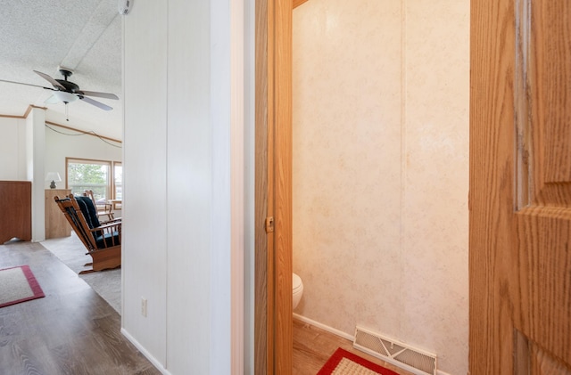 2765 Fraser St, La Prairie, MN 55744 - bathroom with visible vents, wood finished floors, toilet, ceiling fan, and a textured ceiling