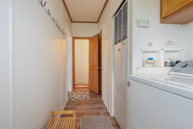 2765 Fraser St, La Prairie, MN 55744 - clothes washing area featuring cabinet space, crown molding, a heating unit, washer / dryer, and light wood-type flooring