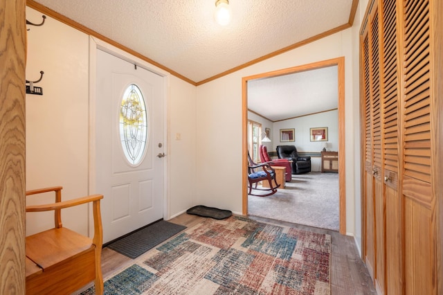 2765 Fraser St, La Prairie, MN 55744 - entrance foyer featuring crown molding, vaulted ceiling, a textured ceiling, and wood finished floors