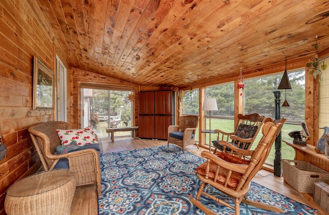 2765 Fraser St, La Prairie, MN 55744 - living room with wood walls, a healthy amount of sunlight, wood finished floors, lofted ceiling, and wood ceiling