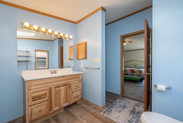 2765 Fraser St, La Prairie, MN 55744 - ensuite bathroom featuring vanity, ornamental molding, wood finished floors, toilet, and ensuite bath