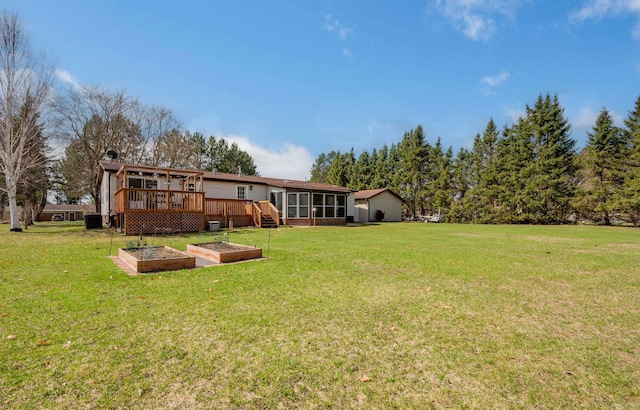 2765 Fraser St, La Prairie, MN 55744 - view of yard featuring a sunroom, a garden, and a wooden deck