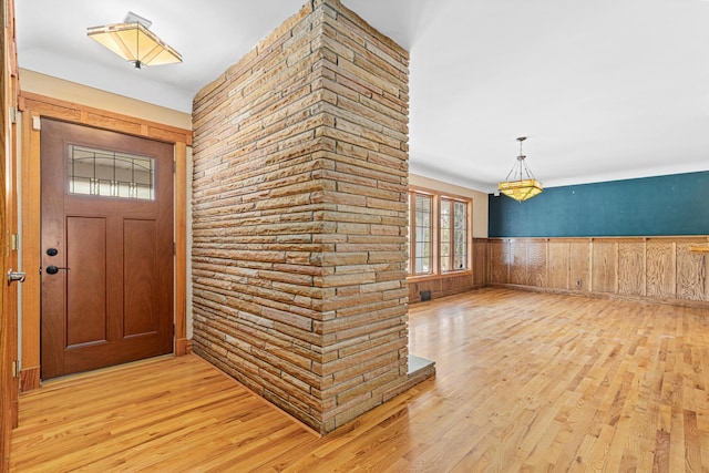 636 County Road B E, Maplewood, MN 55117 - foyer featuring light wood-style floors, wainscoting, and wooden walls