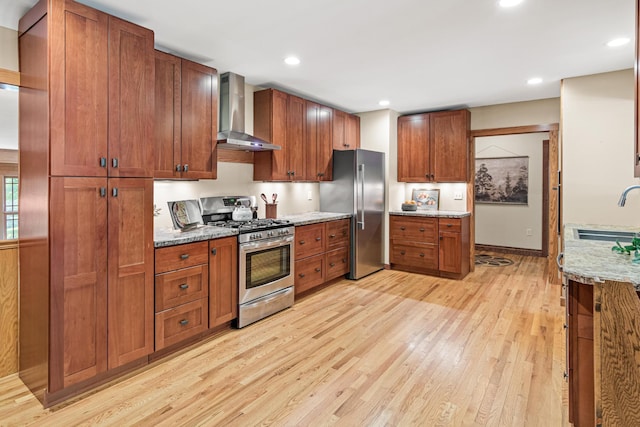 636 County Road B E, Maplewood, MN 55117 - kitchen featuring stainless steel appliances, wall chimney exhaust hood, light wood-style floors, light stone countertops, and recessed lighting