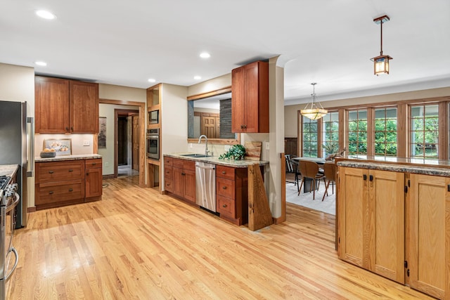 636 County Road B E, Maplewood, MN 55117 - kitchen featuring stainless steel appliances, light wood-style flooring, plenty of natural light, pendant lighting, and recessed lighting