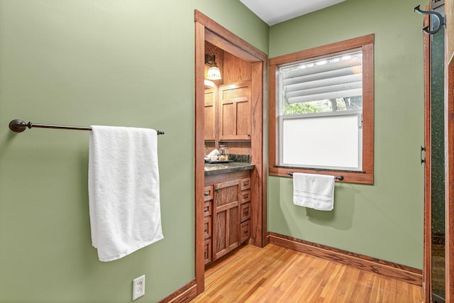 636 County Road B E, Maplewood, MN 55117 - bathroom featuring wood finished floors and baseboards