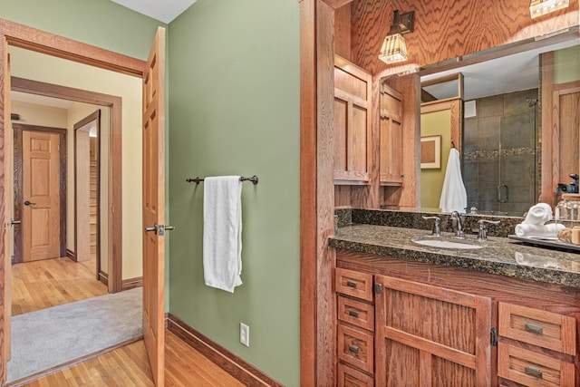 636 County Road B E, Maplewood, MN 55117 - bathroom with wood finished floors, vanity, and a stall shower