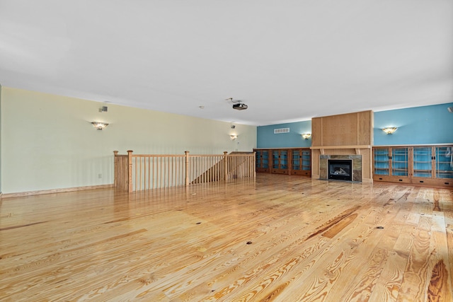 636 County Road B E, Maplewood, MN 55117 - unfurnished living room featuring wood-type flooring and a tiled fireplace
