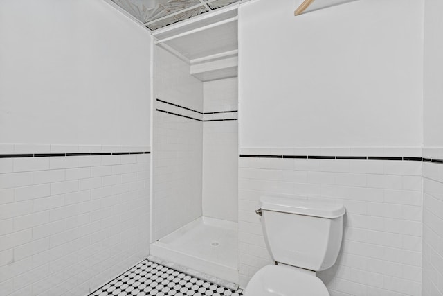 636 County Road B E, Maplewood, MN 55117 - bathroom with tile walls, a tile shower, and wainscoting