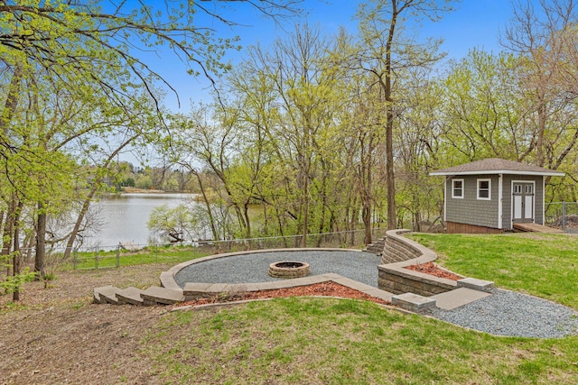 636 County Road B E, Maplewood, MN 55117 - view of yard featuring an outdoor fire pit, a water view, and an outdoor structure
