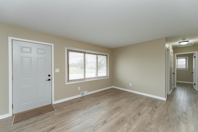 entrance foyer featuring baseboards, visible vents, and light wood-style floors
