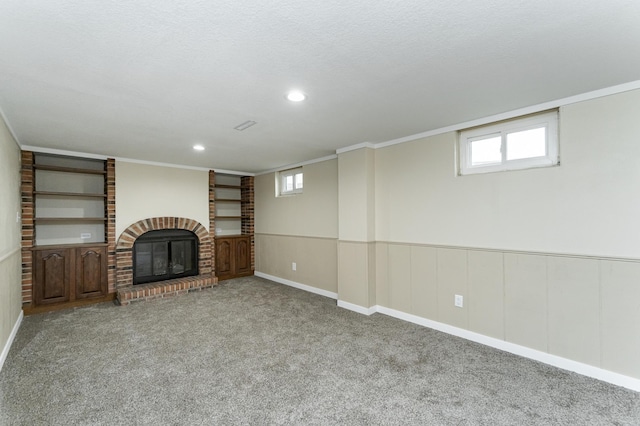 unfurnished living room with crown molding, carpet floors, a fireplace, and recessed lighting
