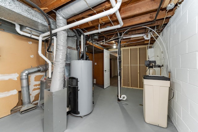 unfinished below grade area featuring water heater and concrete block wall