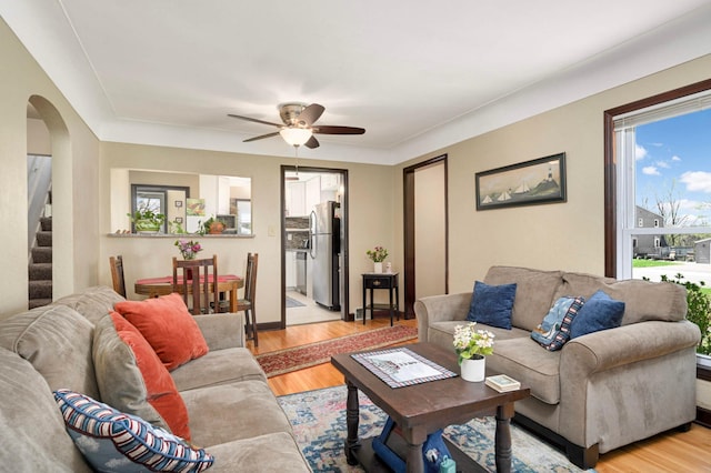 1100 Summit Ave, Saint Paul Park, MN 55071 - living area featuring arched walkways, stairway, a ceiling fan, and light wood finished floors