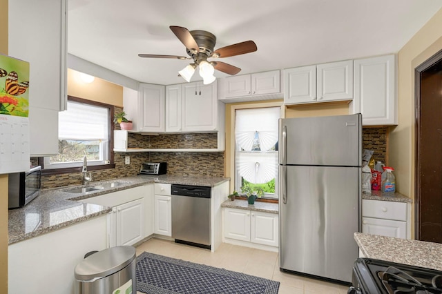 1100 Summit Ave, Saint Paul Park, MN 55071 - kitchen featuring stainless steel appliances, a sink, white cabinetry, a ceiling fan, and decorative backsplash